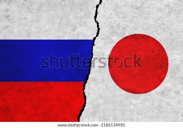 Russia and\
Japan painted flags on a wall with a crack. Russia and Japan\
relations. Japan and Russia flags\
together