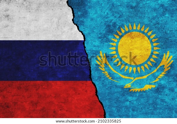Russia and Kazakhstan painted flags on a wall\
with a crack. Russia and Kazakhstan relations. Kazakhstan and\
Russia flags\
together