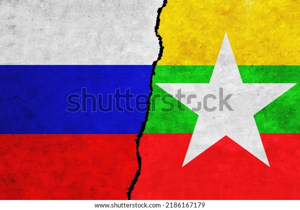 Russia and Myanmar painted flags on a wall with\
a crack. Russia and Myanmar relations. Myanmar  and Russia flags\
together