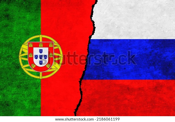 Russia and Portugal painted flags on a wall with\
a crack. Russia and Portugal relations. Portugal and Russia flags\
together