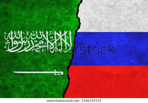Russia and Saudi Arabia painted flags on a wall\
with a crack. Russia and Saudi Arabia relations. Saudi Arabia and\
Russia flags\
together