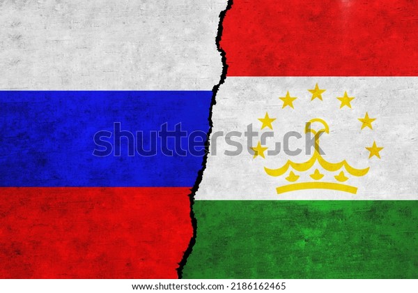 Russia and Tajikistan painted flags on a wall\
with a crack. Russia and Tajikistan relations. Tajikistan and\
Russia flags\
together