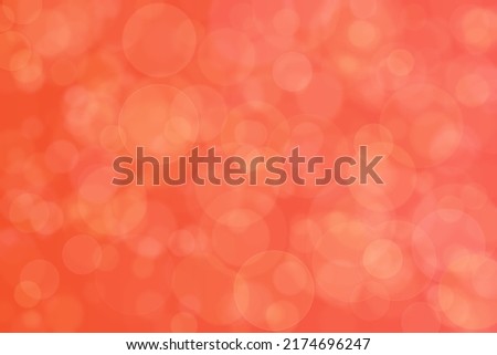 Salmon colored abstract background. Orange red defocused spots.