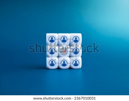 Same target, teamwork, organization, colleague, team collaboration concepts. Goal symbol at the center of person icon with objective arrows on white dice blocks stack isolated on blue background.