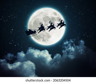 Santa Claus in a sleigh flying over the moon in the night - Powered by Shutterstock