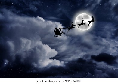 Santa On A Sleigh With Rein Deers Over The Full Moon