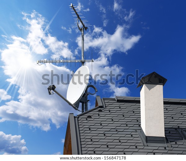 Satellite Dish\
and Antenna TV on Blue Sky / Satellite dish and TV antennas on the\
house roof with a beautiful blue\
sky