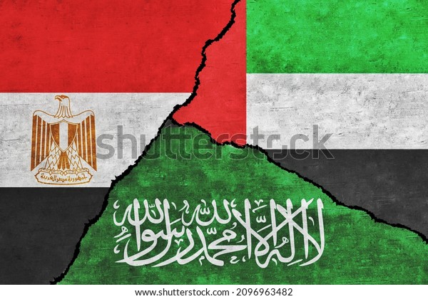 Saudi\
Arabia, Egypt and UAE painted flags on a wall with a crack. United\
Arab Emirates, Egypt and Saudi Arabia\
relations