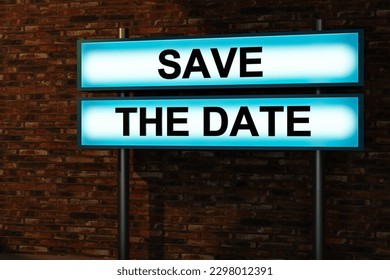 Save the date. Black letters on a light box illuminated in front of a red brick wall. Scheduling, appointment, reminder, message, dating, information, countdown and public event. 3D illustration - Powered by Shutterstock