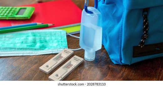 School Coronavirus Protection Concept. Rapid Test, Hand Sanitizer And Student Backpack On Wooden Desk. Covid 19 Outbreak Prevention. 3d Illustration