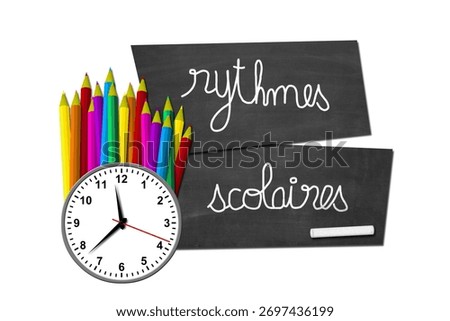 School rhythms with the French expression " Rythmes scolaires " written on a slate with a clock and colored pencils placed randomly on the left