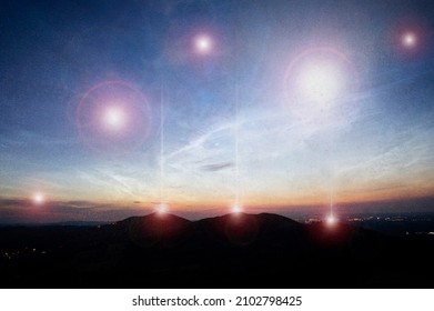 A Science Fiction Concept. Of Glowing UFO Lights Floating Above Hills And A City Just Before Sunrise. 