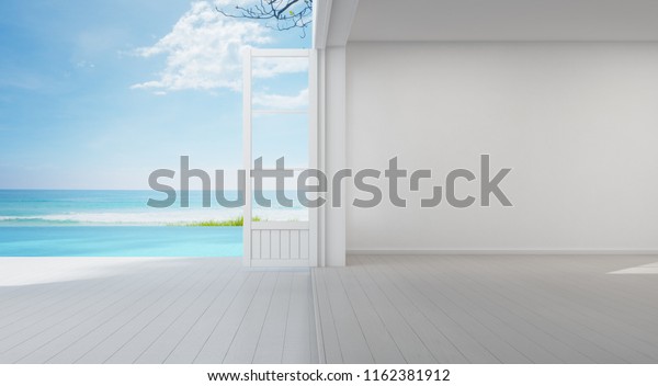 海水浴場の近くにガラス戸と木製の床テラスを持つ 豪華な夏のビーチハウスの海景色の部屋 休暇中の家や別荘の背景に空の白い壁 ホテルのインテリア3dイラスト のイラスト素材