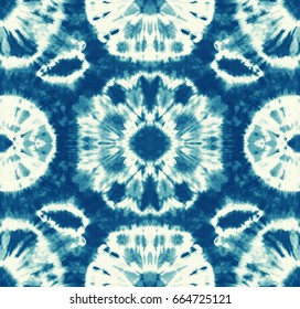 Seamless pattern, abstract batik tie dyed fabric of indigo color on white cotton. Hand painted tie-dye fabrics. Shibori dyeing