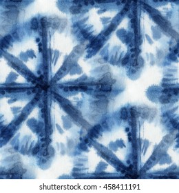 Seamless tie-dye pattern with circles of indigo color on white silk. Hand painting fabrics - nodular batik. Shibori dyeing. 