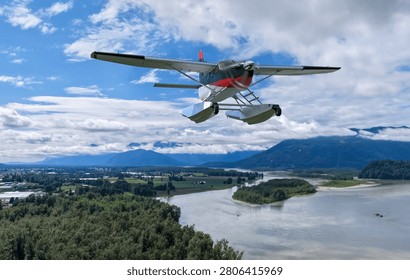 Seaplane floatplane flying above a river valley and mountain landscape in British Columbia, Canada; 3d Rendering, Background in BC, Canada.