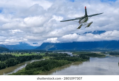 Seaplane floatplane flying over a river valley with mountains and dramatic clouds, 3d rendering, Background in BC, Canada.