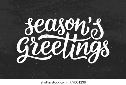 Seasons Greetings Calligraphy Lettering Text On Black Chalkboard Background. Retro Greeting Card For Christmas And New Year Holidays.