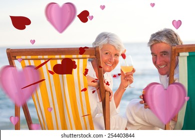 Senior couple drinking a cocktail against love heart pattern - Powered by Shutterstock