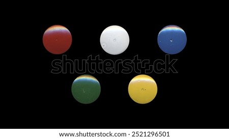 a set of colorful aged circles, rusty stationery tacks, isolated front view metal push rounded pins on black background