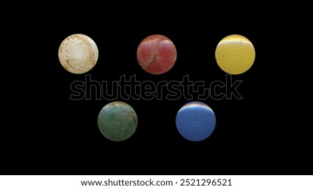 a set of colorful aged circles, rusty stationery tacks, isolated front view metal push rounded pins on black background