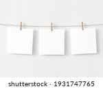 Set of three note paper cards hanging with wooden clip or clothespin on rope string peg isolated on white backgroun. 3D illustration