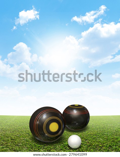 A set of wooden\
lawn bowls next to a jack on a perfect flat green lawn against a\
blue sky with white\
clouds