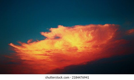 A setting sun colors a white cumulus cloud in explosive hues of dark red, orange and yellow.