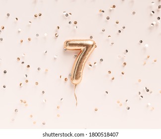 Seven year birthday. Number 7 flying foil balloon and confetti. Seven-year anniversary background. 3D rendering