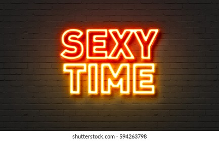 Sexy time neon sign on brick wall background