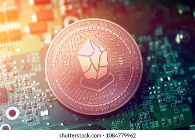 shiny copper LISK cryptocurrency coin on blurry motherboard background