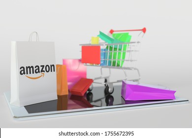 Shopping Cart On A Tablet Computer And Paper Bag With Amazon Logo. Editorial E-commerce Related 3D Rendering