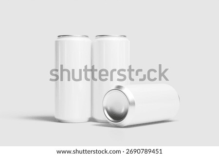 Showcases three generic beverage cans for design presentation, two standing and one lying down on a light background