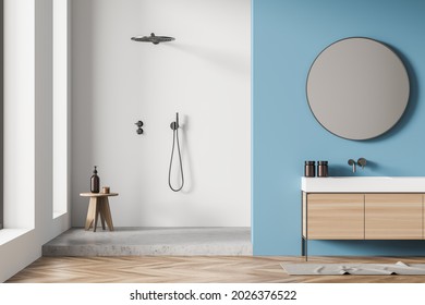 Shower Room Interior With White And Grey Shower Cabin, Stool, On Trend Round Mirror, Vanity And Blue Wall. Wood Tile Floor. A Concept Of Modern House Design. 3d Rendering