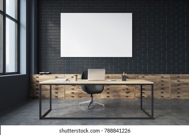 Side Veiw Of A Black Brick CEO Office Interior With A Concrete Floor, A Large Table With A Computer On It And A Poster. Front View. 3d Rendering Mock Up