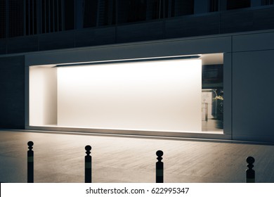 Side View Of Empty Glass Shopfront With Blank White Poster At Night. Retail  Concept. Mock Up, 3D Rendering