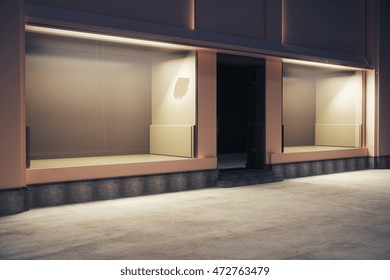 Side view of empty storefront at night. Mock up, 3D Rendering
