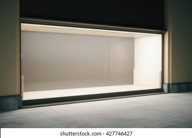 Side view of shop exterior with large empty showcase at night. Mock up, 3D Rendering