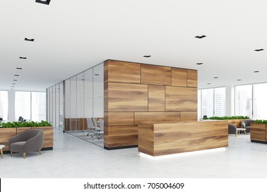 Side View Of A Wooden Reception Desk Standing In An Open Space Office Environment With Rows Of Computer Tables And Loft Windows. 3d Rendering Mock Up