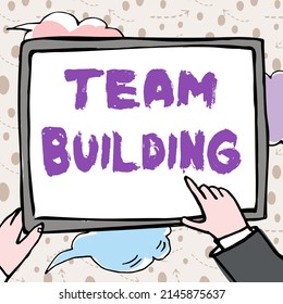 Sign Displaying Team Building. Conceptual Photo Types Of Activities Used To Enhance Social Relations Hands Holding Paper Showing New Ideas Surrounded With Stars.