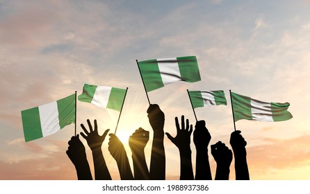Silhouette of arms raised waving a Nigeria flag with pride. 3D Rendering