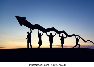 Silhouette of business people and graph at sky and sunset background.  Cooperate, success, teamwork and goal concept. - Shutterstock ID 1102071608