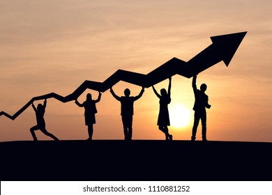 Silhouette of business people and graph at sky and sunset background.  Cooperate, success, teamwork and goal concept. - Shutterstock ID 1110881252