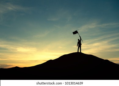 Silhouette of businessman celebrating success on top of hill, sky and sun light background.  Vintage filter. Business, success, leadership, achievement, teamwork and people concept.