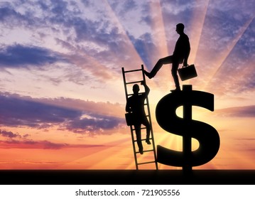 Silhouette Of A Businessman Climbs The Stairs, And Another Businessman Standing On A Dollar Symbol Pushes This Ladder. The Concept Of Greed And Inequality