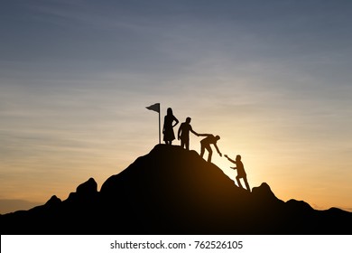 Silhouette of businessman helping each other hike up a mountain at sunrise. Business teamwork success concept. Vintage filter.