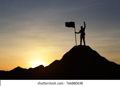 Silhouette of businessman holding a flag on top mountain, sky and sun light background. Vintage filter. Business, success, leadership, achievement and goal concept.