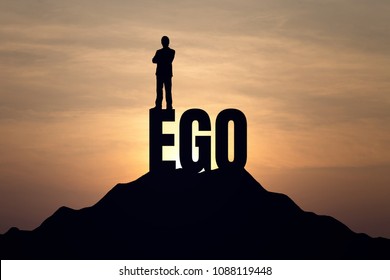 Silhouette of businessman standing on EGO text at Mountain, sky and sun light background. Business, success, challenge, motivation, achievement and goal concept.