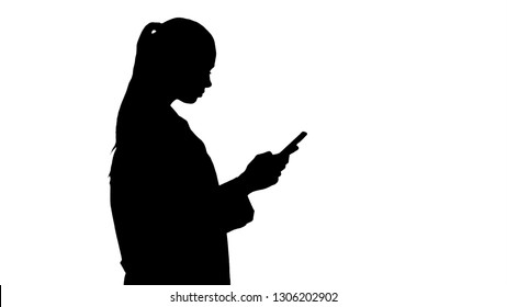 Silhouette Cheerful Cute Young Woman Doctor Typing Text On Phone While Walking.