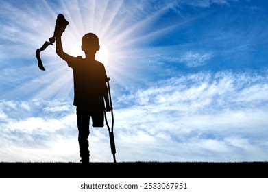 Silhouette of a child with crutches, proudly raising a prosthetic limb against a bright, sunlit sky. It captures the essence of hope, resilience, and the journey of overcoming physical limitations - Powered by Shutterstock